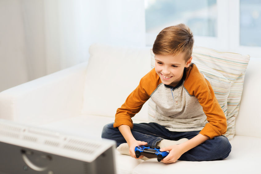 Un niño juega con un videojuego en su habitación.