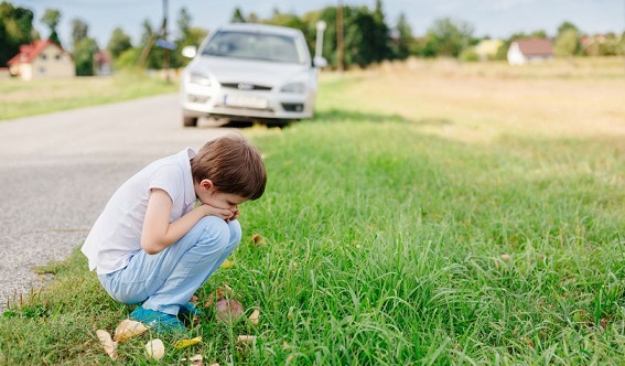 Un niño se marea durante un viaje en el coche.